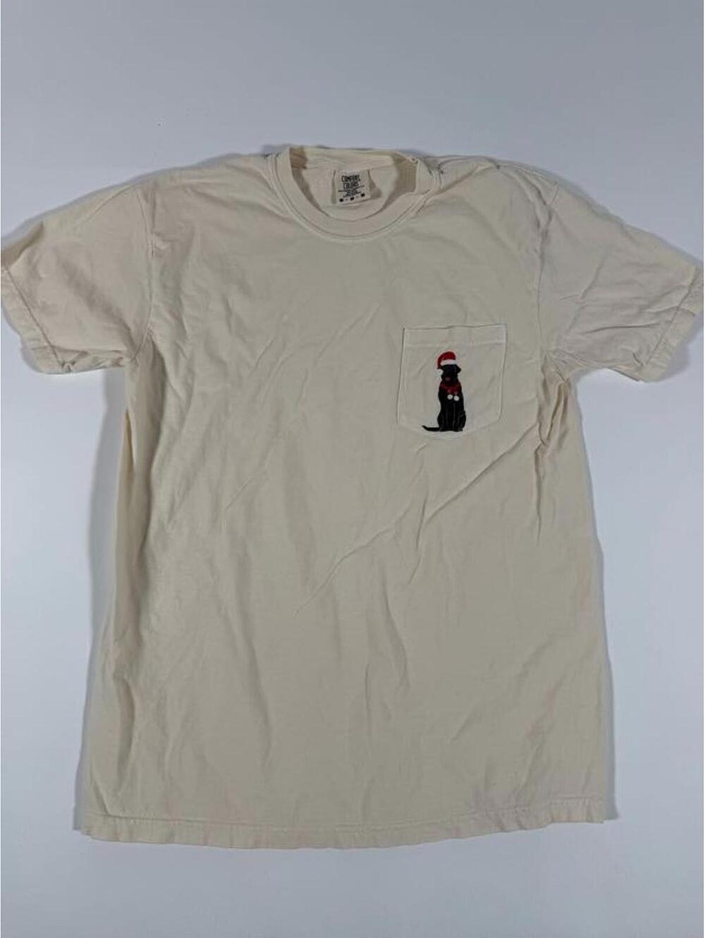 Cream Pocket T-Shirt with Black Dog Wearing Santa Hat Design